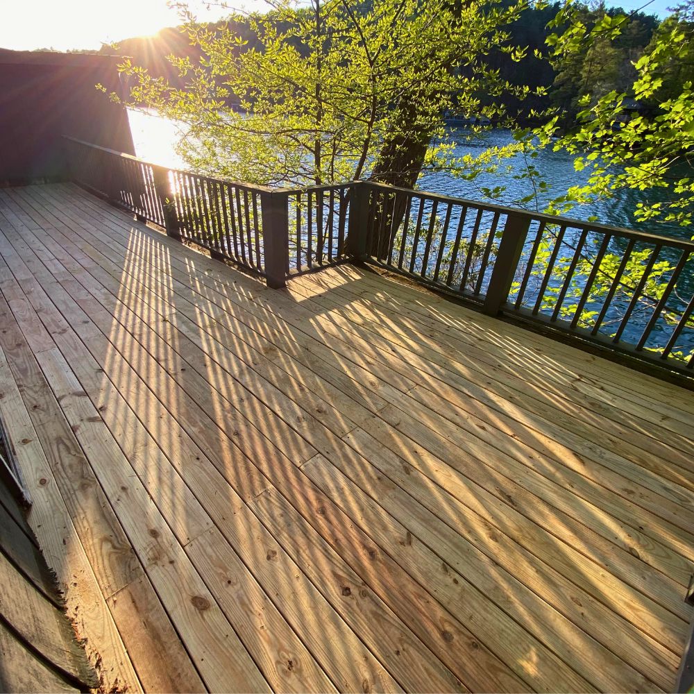 Sunshine is peeping through the deck rails casting beautiful light with lake in background